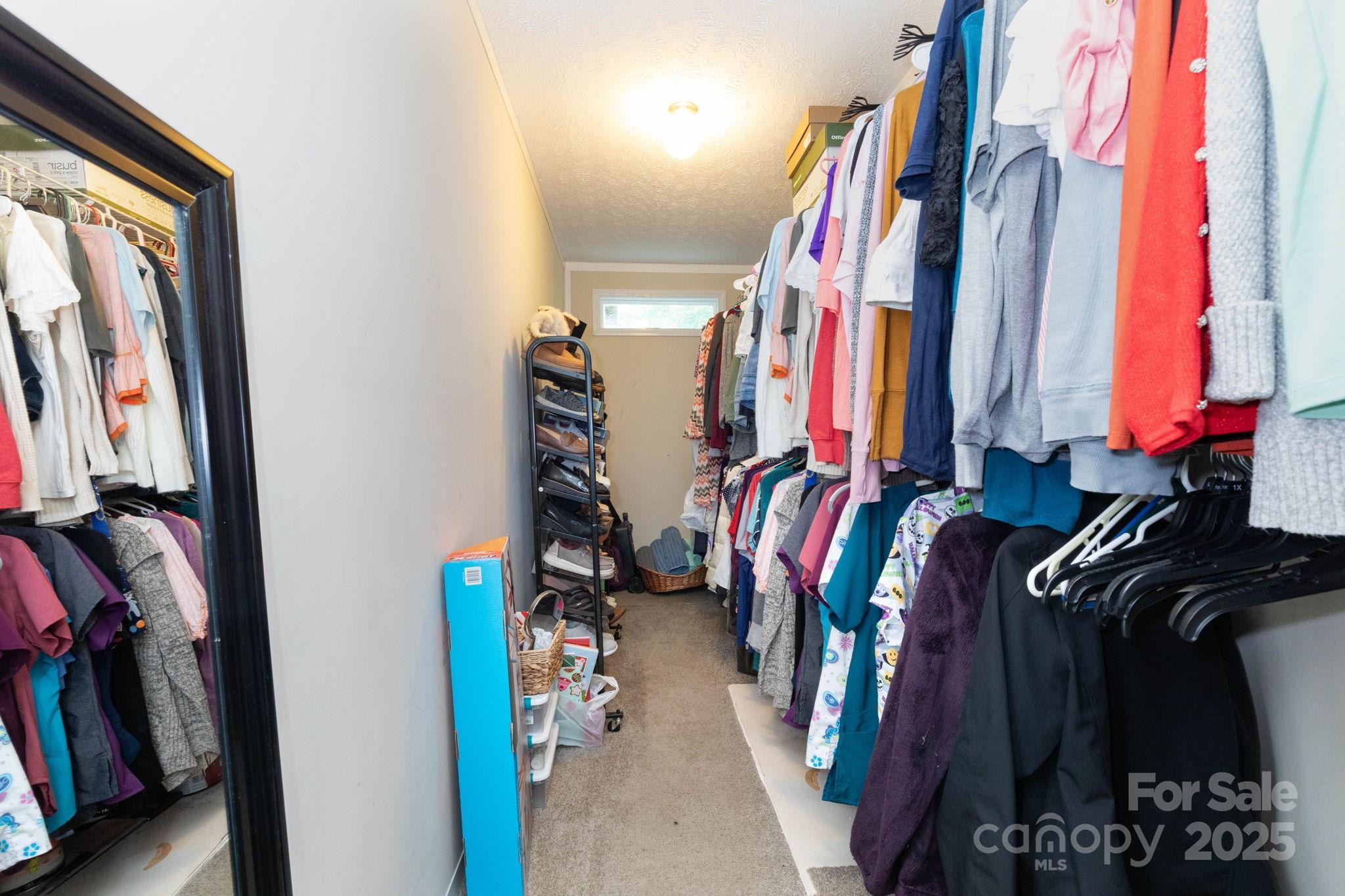 324 Lytle Cove Road Swannanoa, NC 28778 - Photo 17 of 27 a view of walk in closet with clothes and shoes