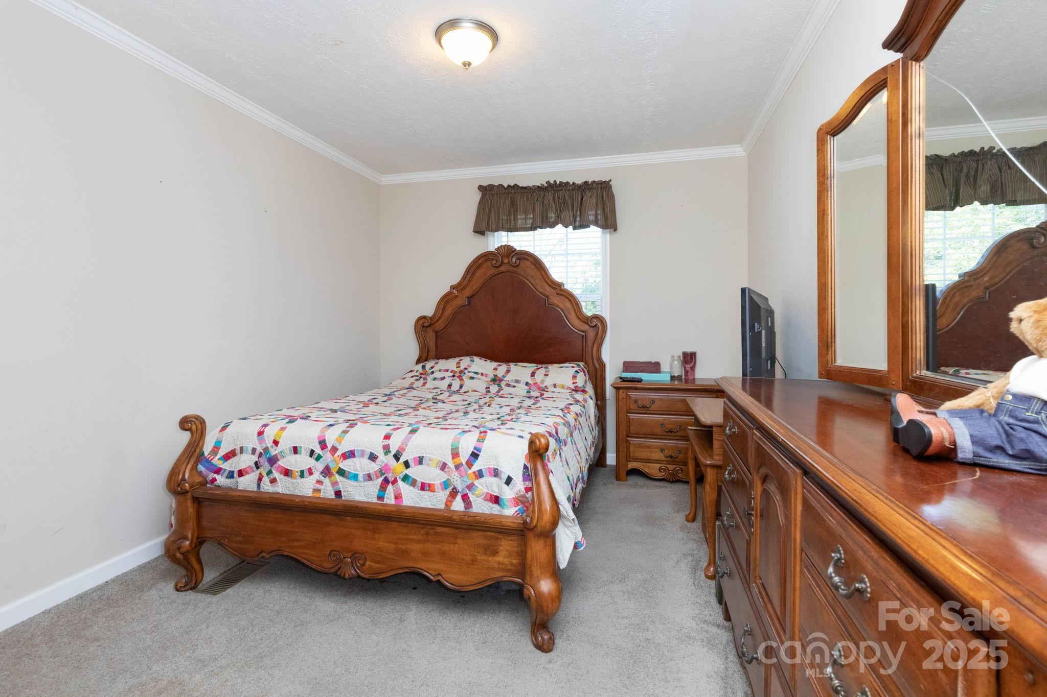 324 Lytle Cove Road Swannanoa, NC 28778 - Photo 19 of 27 a bedroom with a bed and a window