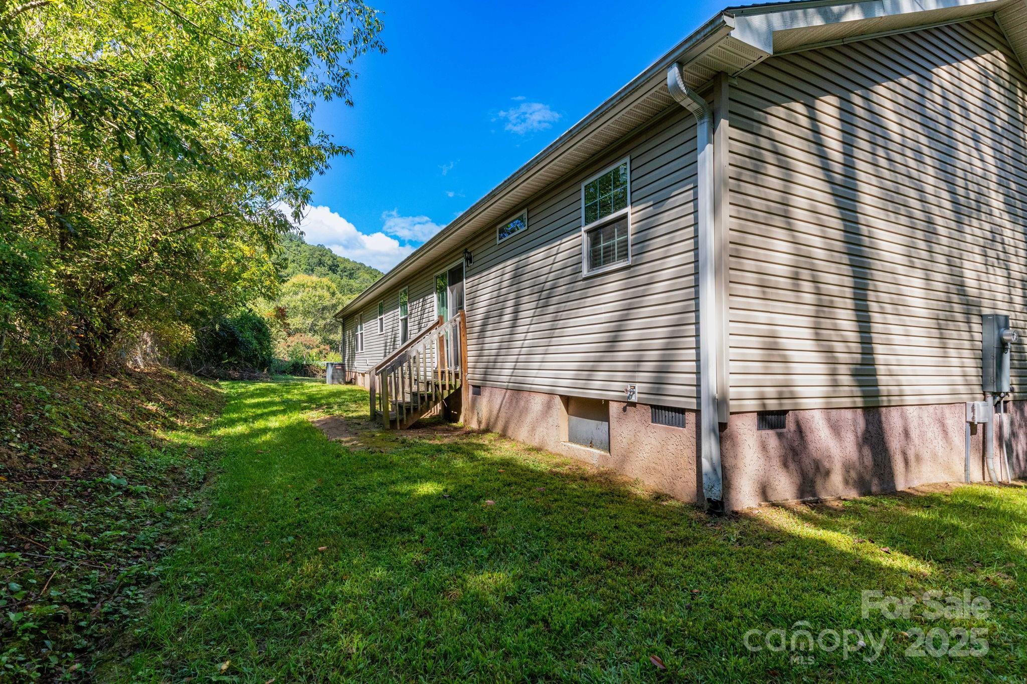 324 Lytle Cove Road Swannanoa, NC 28778 - Photo 27 of 27 a view of a house with a backyard