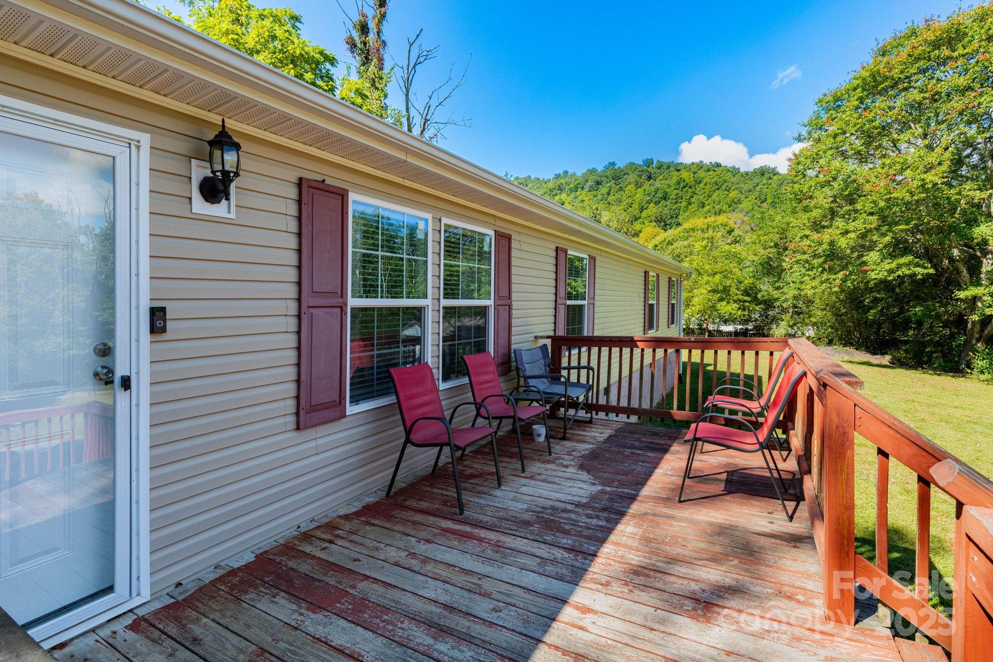 324 Lytle Cove Road Swannanoa, NC 28778 - Photo 6 of 27 a view of a wooden deck with furniture