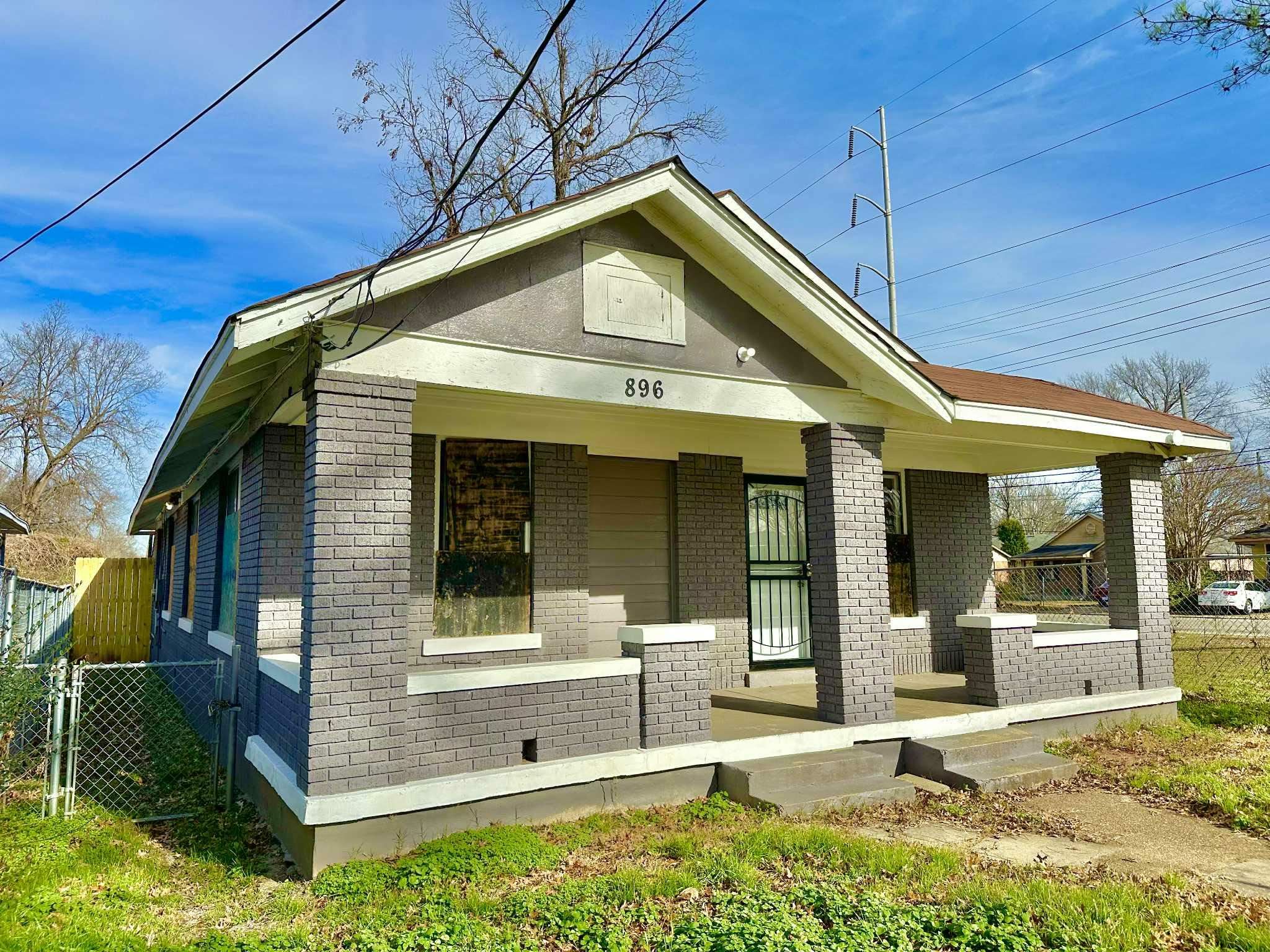 Bungalow with brick siding and covered porch