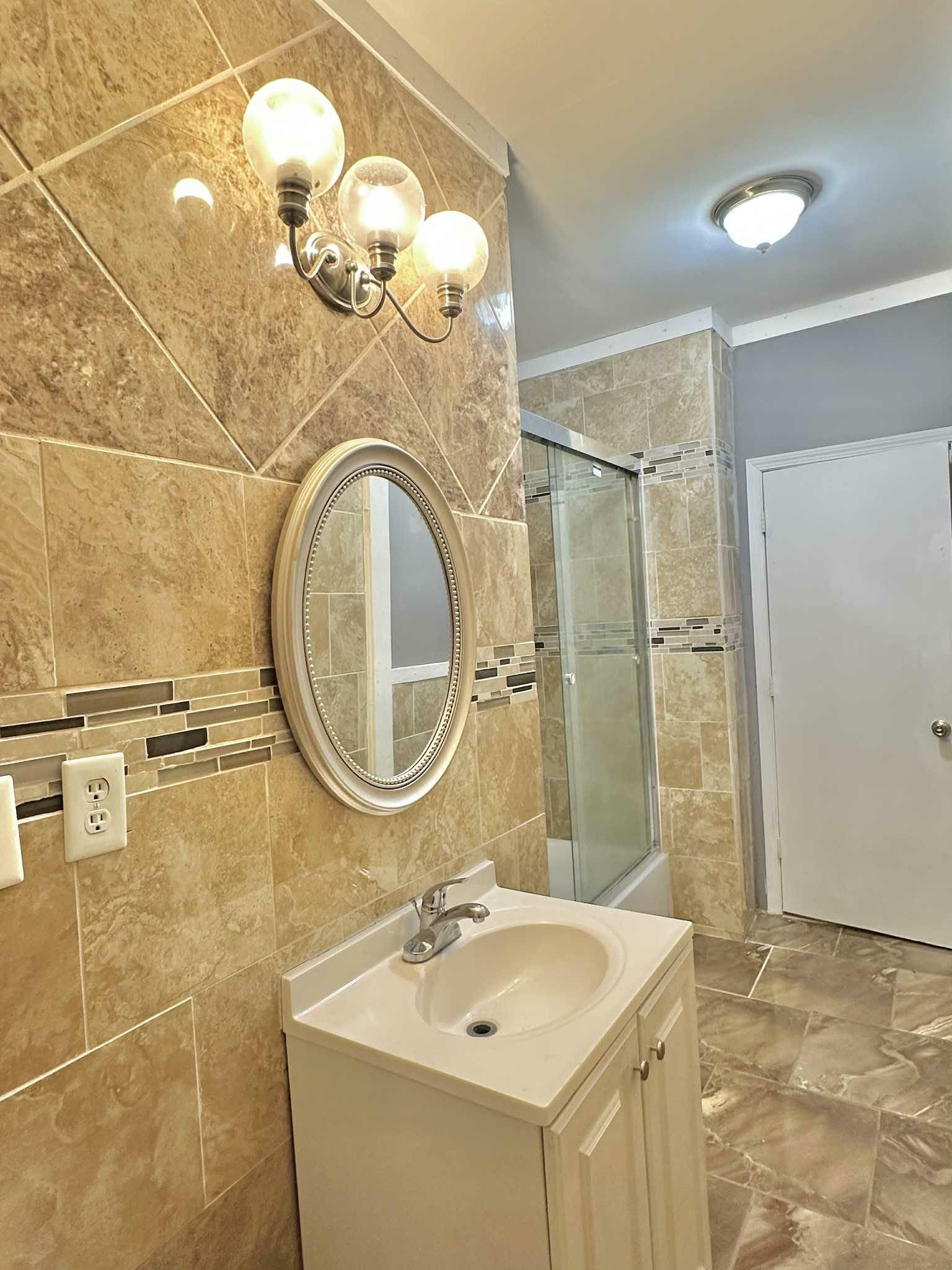 896 Orphanage Avenue Memphis, TN 38107 - Photo 16 of 17 Full bath featuring vanity, tiled shower, tile walls, and crown molding