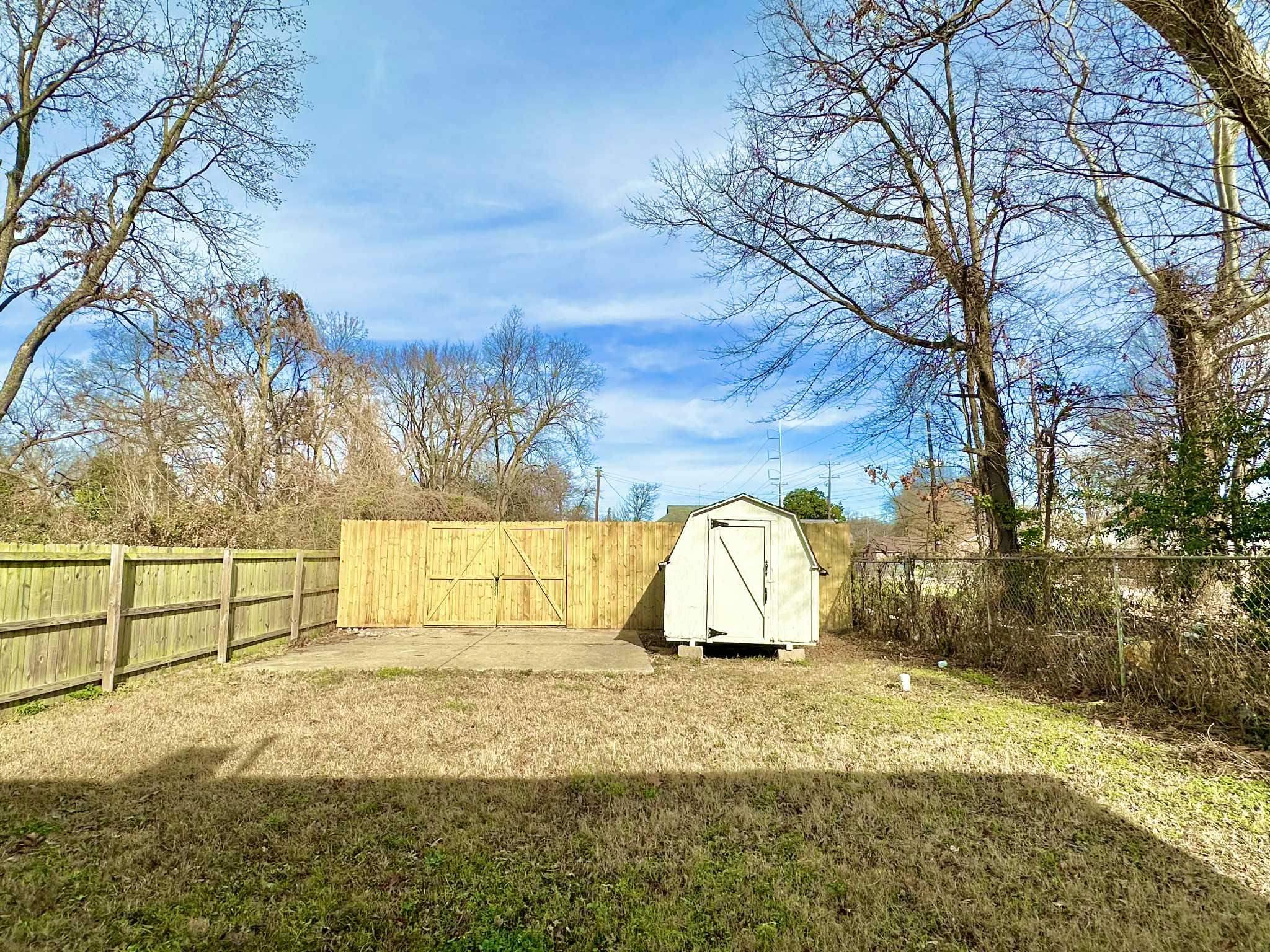 896 Orphanage Avenue Memphis, TN 38107 - Photo 17 of 17 Fenced backyard with a storage shed