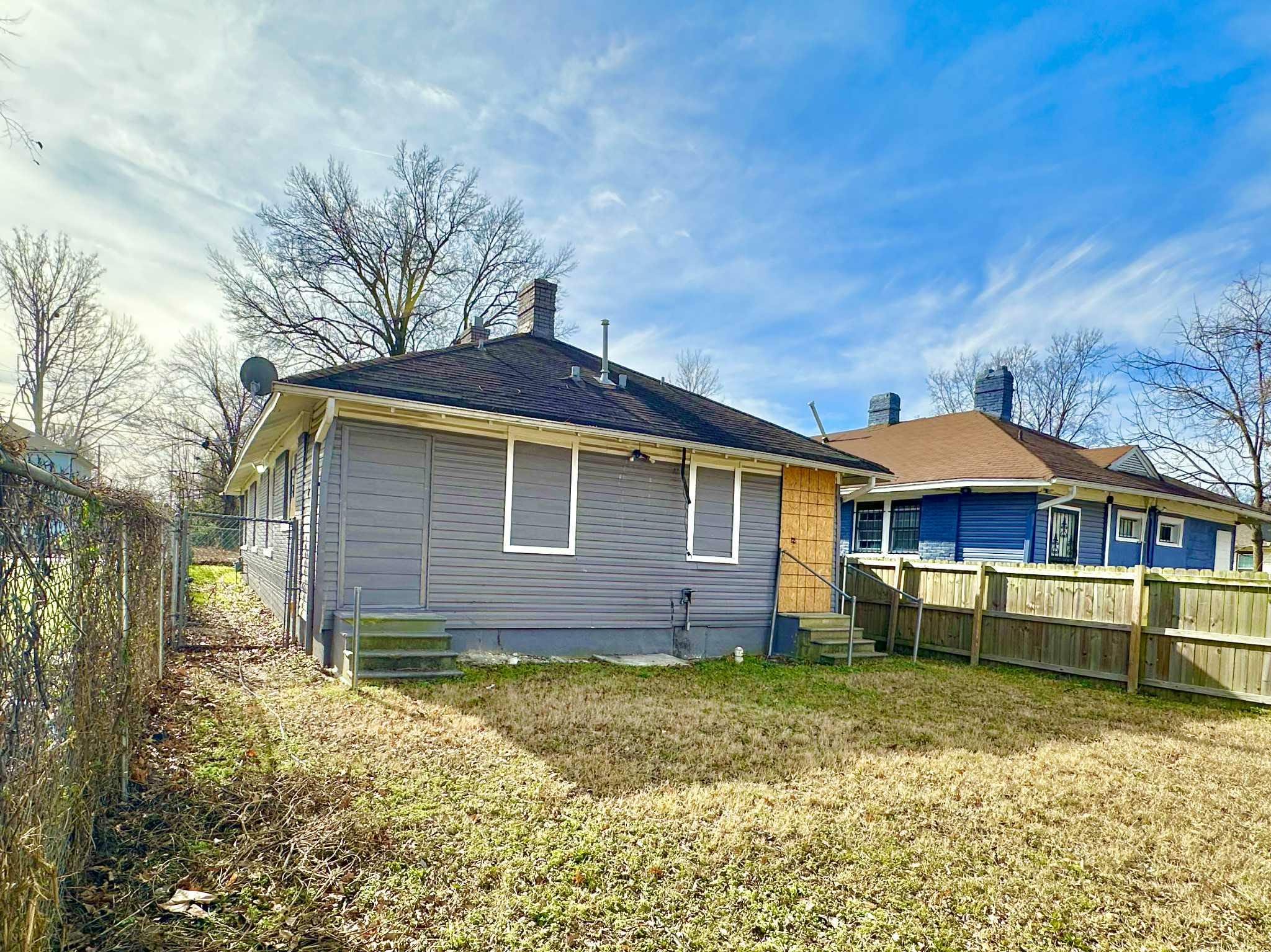 896 Orphanage Avenue Memphis, TN 38107 - Photo 3 of 17 Rear view of house with a fenced backyard, a chimney, and entry steps