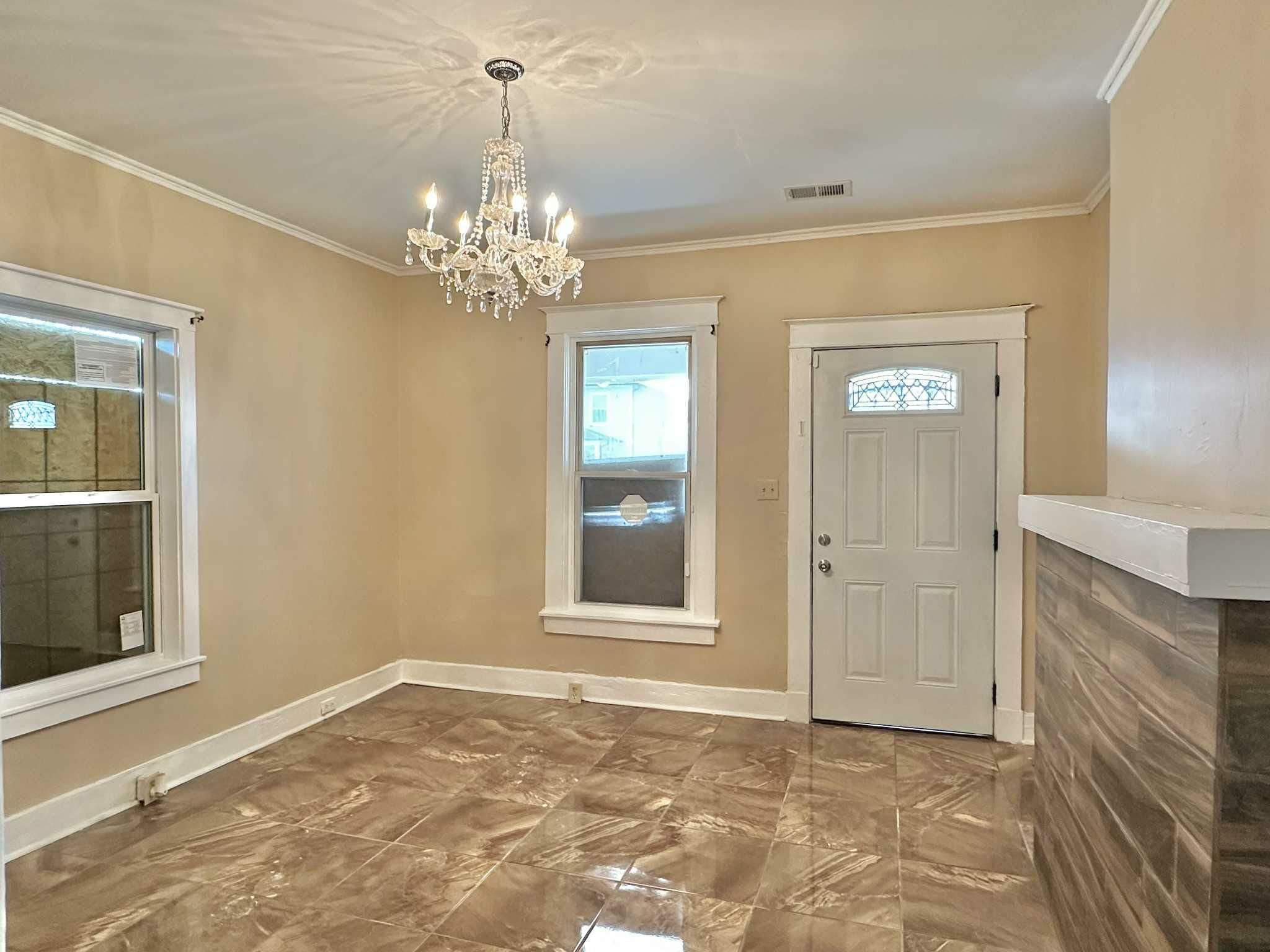 896 Orphanage Avenue Memphis, TN 38107 - Photo 4 of 17 Entryway with marble finish floors, a chandelier, and crown molding