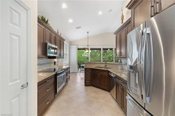 a kitchen with a sink stove and cabinets