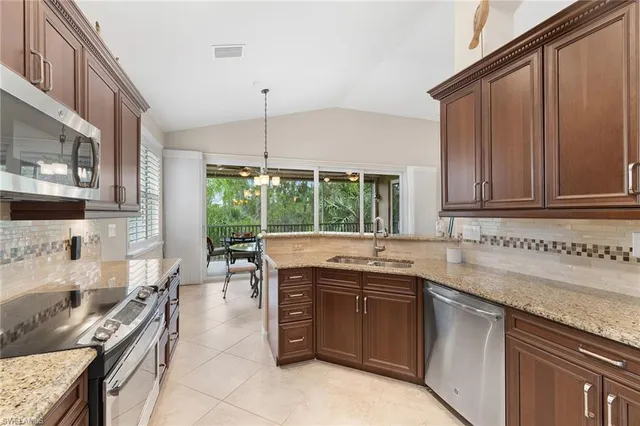 a kitchen with sink refrigerator and cabinets