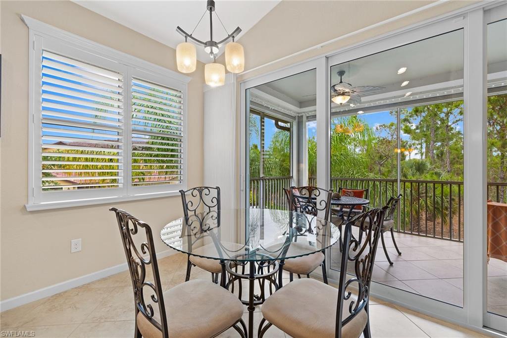 6669 Alden Woods Circle, Unit 7201 Naples, FL 34113 - Photo 15 of 28 a view of a dining room with furniture window and outside view