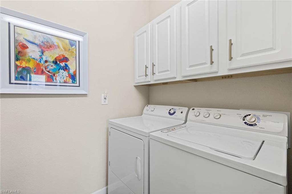 6669 Alden Woods Circle, Unit 7201 Naples, FL 34113 - Photo 24 of 28 a utility room with dryer and washer