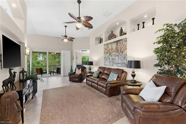 a view of a livingroom with furniture water view and a large window