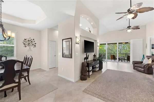a dining room with furniture a chandelier and window