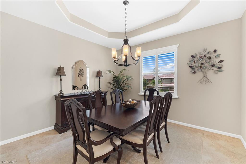 6669 Alden Woods Circle, Unit 7201 Naples, FL 34113 - Photo 10 of 28 a dining room with furniture a chandelier and window