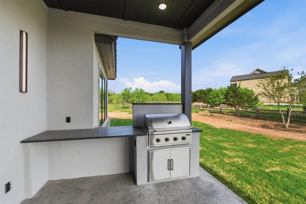 2025 Limestone Trail Graford, TX 76449 - Photo 27 of 33 a open kitchen with stainless steel appliances kitchen island a stove and a sink