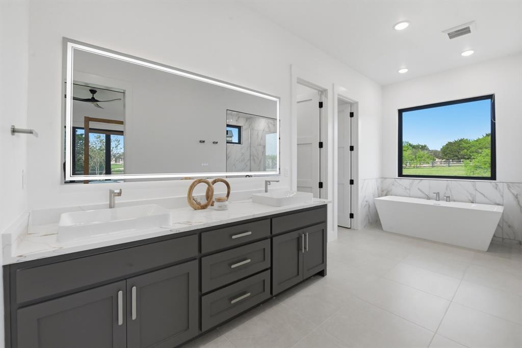 2025 Limestone Trail Graford, TX 76449 - Photo 8 of 33 a spacious bathroom with a tub double sink and mirror