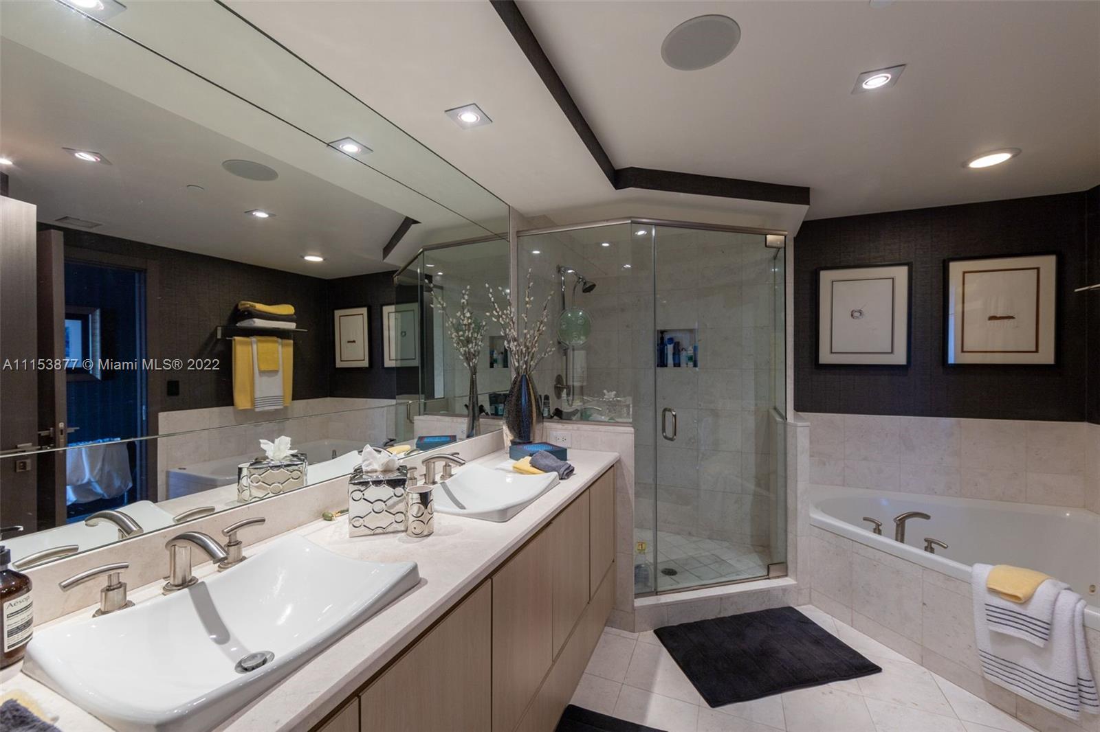 901 Brickell Key Boulevard, Unit 704 Miami, FL 33131 - Photo 12 of 39 a bathroom with a tub sink shower and mirror