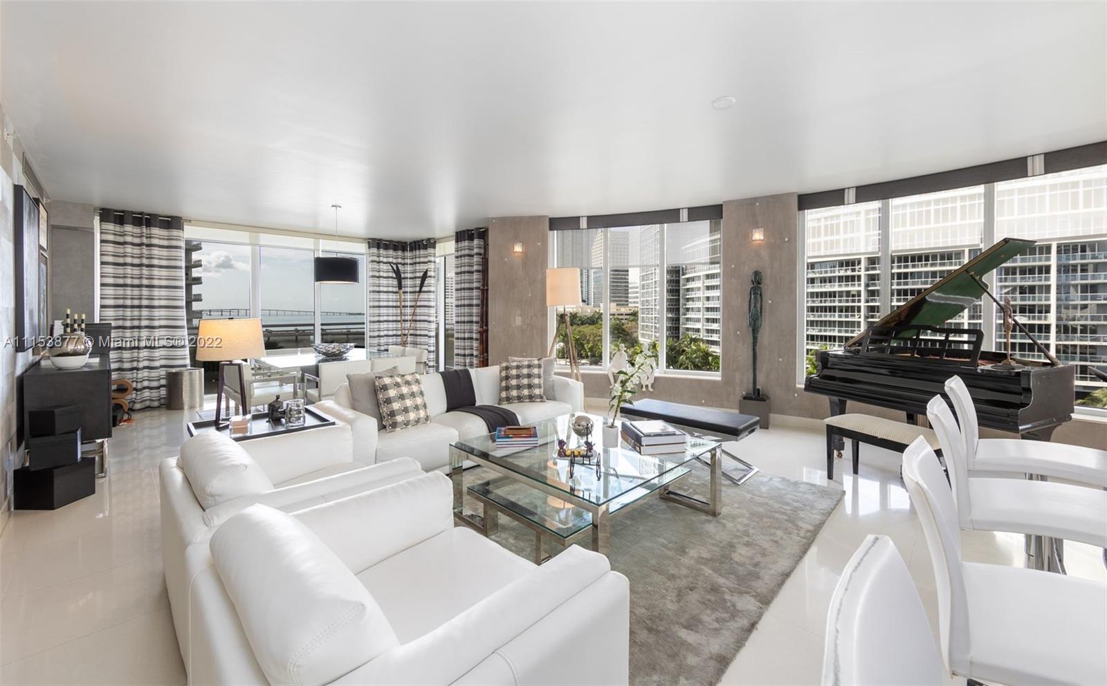 901 Brickell Key Boulevard, Unit 704 Miami, FL 33131 - Photo 2 of 39 a living room with furniture and floor to ceiling windows