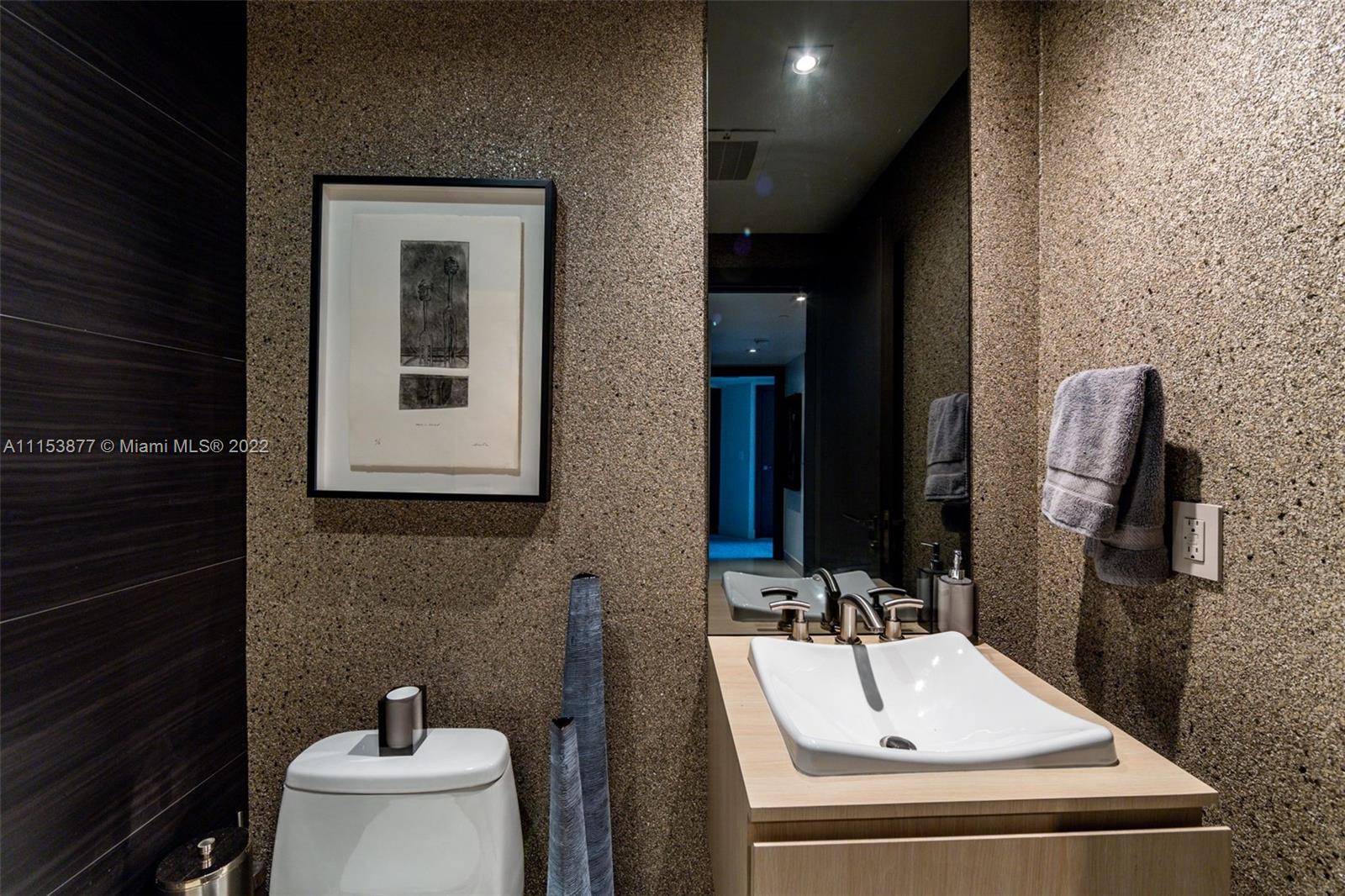 901 Brickell Key Boulevard, Unit 704 Miami, FL 33131 - Photo 7 of 39 a bathroom with a sink and a mirror