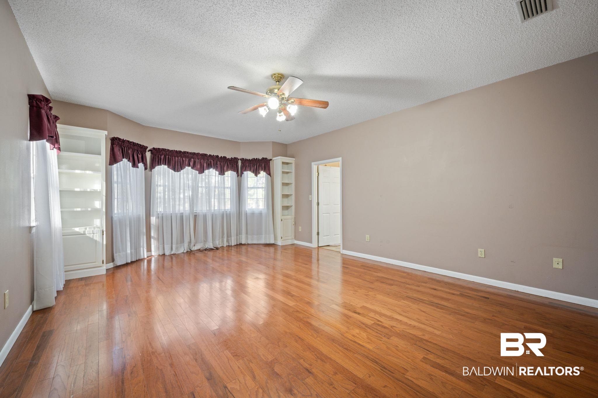 15801 Maytower Road Bay Minette, AL 36507 - Photo 10 of 43 Unfurnished room featuring ceiling fan, a textured ceiling, and hardwood / wood-style flooring