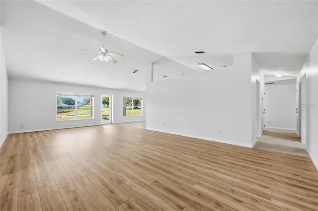 a spacious bedroom with a bed and a window