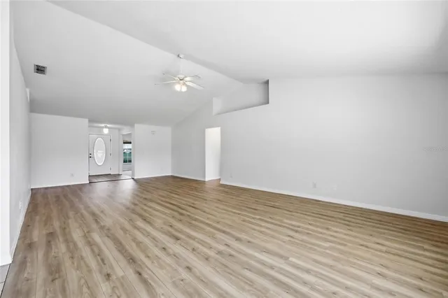 wooden floor in an empty room with a window