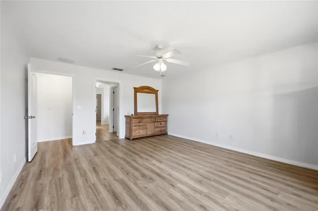 a front view of a house with a yard and potted plants