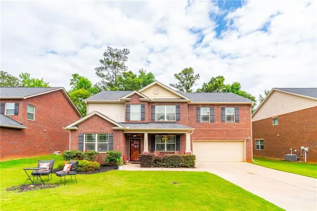 a front view of a house with garden