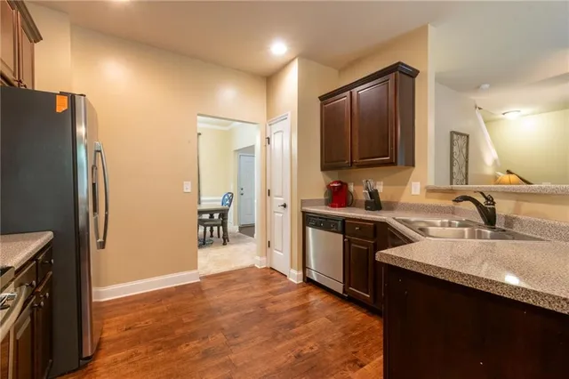 a kitchen with stainless steel appliances granite countertop a refrigerator stove and sink