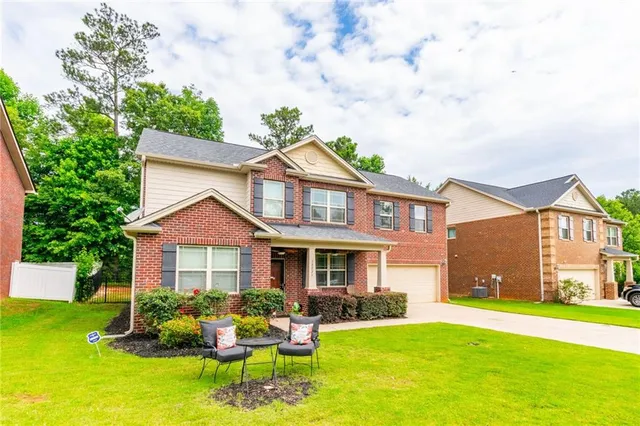 a front view of a house with a garden and porch
