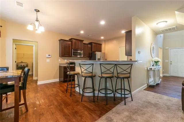 a view of a dining room with furniture and wooden floor