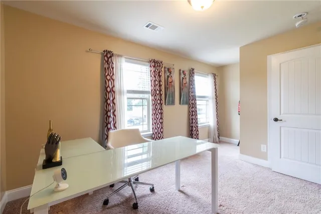 a view of a livingroom with furniture and windows