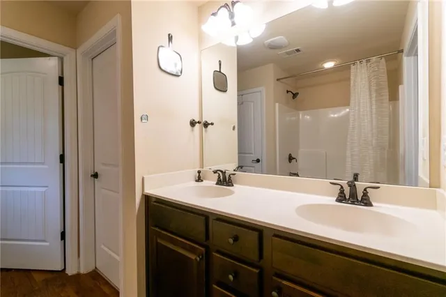 a bathroom with a double vanity sink mirror and double