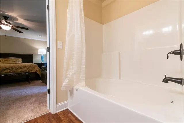 a bathroom with a tub and a shower