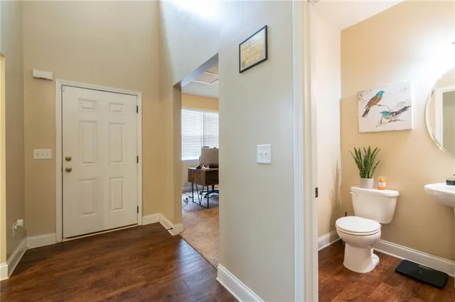 a bathroom with a toilet and a view of bathroom