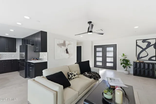 a bedroom with a large bed and a chandelier