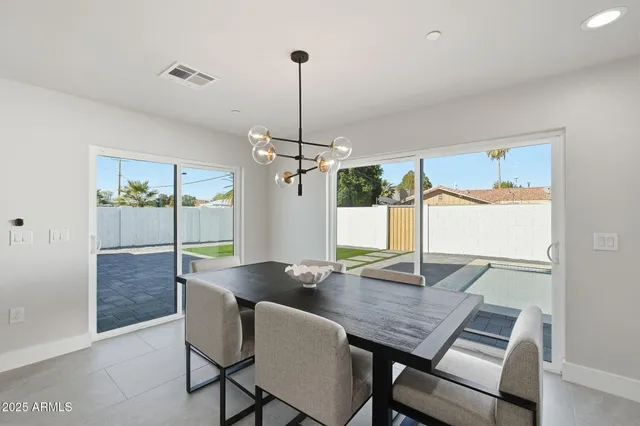 a large kitchen with sink a counter top space and living room view
