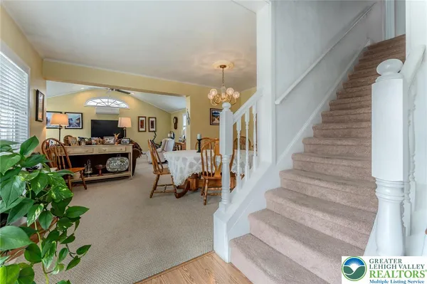 a kitchen with kitchen island granite countertop a stove top oven a sink a dining table and chairs