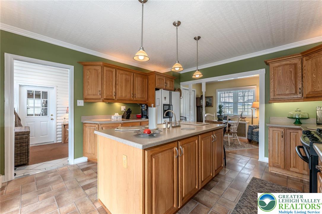 181 Springhouse Road Lehighton, PA 18235 - Photo 33 of 71 a kitchen with kitchen island a stove a sink a center island and wooden cabinets