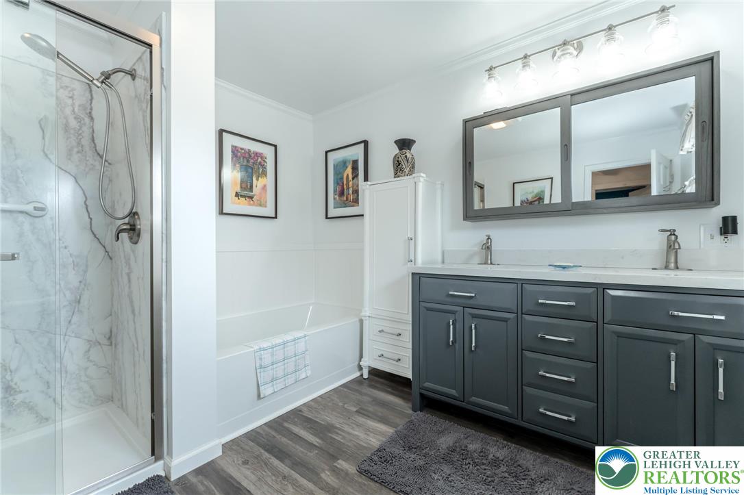 181 Springhouse Road Lehighton, PA 18235 - Photo 42 of 71 a bathroom with a granite countertop sink a mirror a vanity and a shower