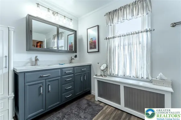 a living room with furniture a flat screen tv and kitchen view