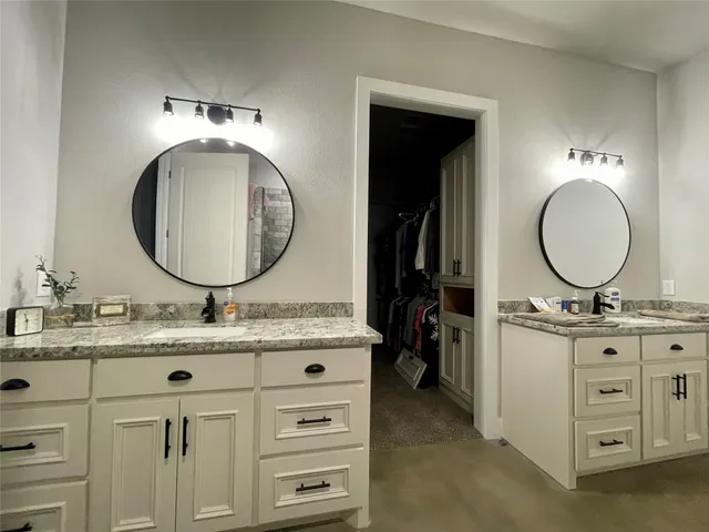a bathroom with a sink and mirror