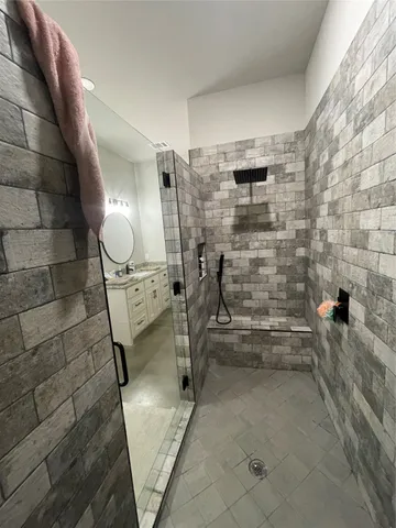 a bathroom with a shower and a sink