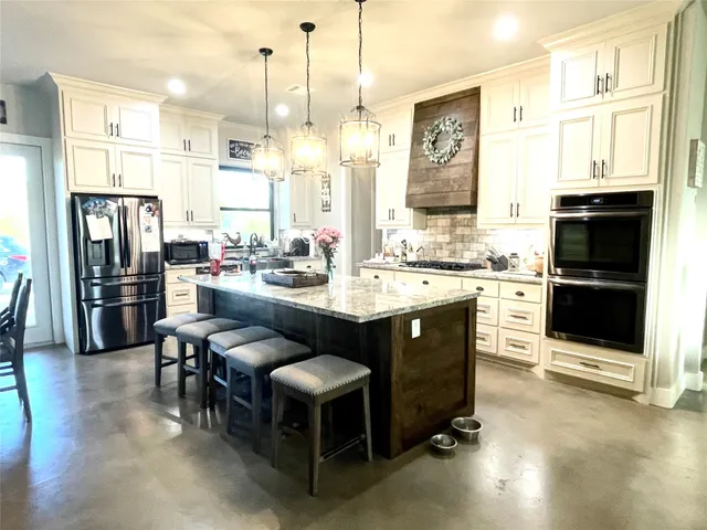 a kitchen with a sink appliances and cabinets