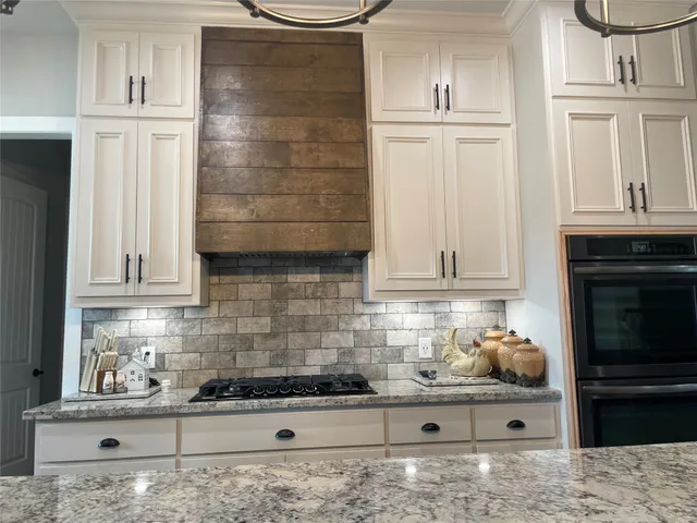 a kitchen with appliances and cabinets