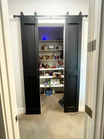 a view of a dining room with furniture and a chandelier