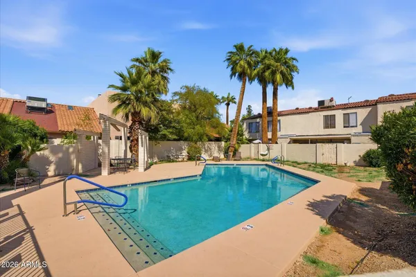 a view of a house with pool and sitting area