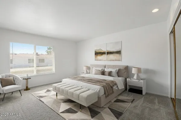 a bedroom with a bed and a couch