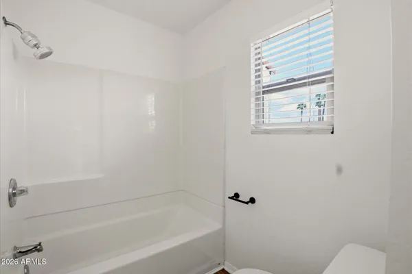 a bathroom with a bathtub and shower
