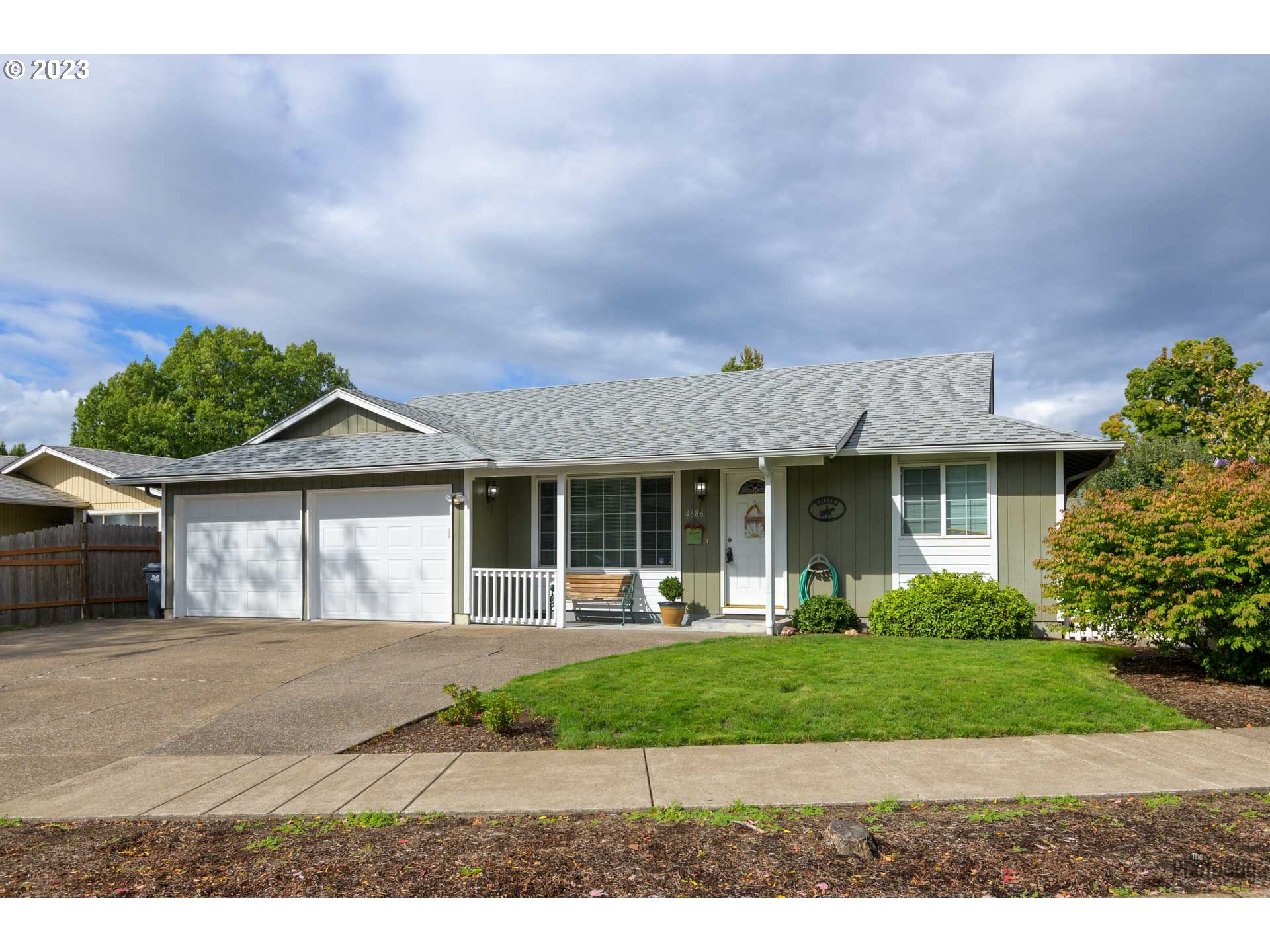4888 B Street Springfield, OR 97478 - Photo 1 of 32 a front view of a house with a yard and potted plants
