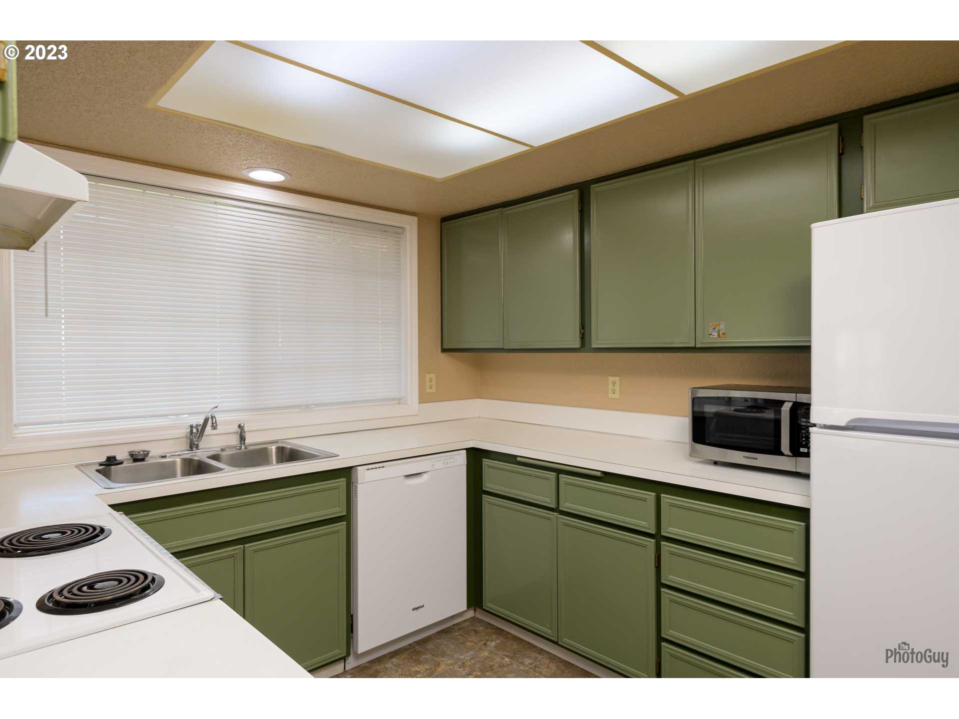 4888 B Street Springfield, OR 97478 - Photo 11 of 32 a kitchen with a sink a stove and cabinets