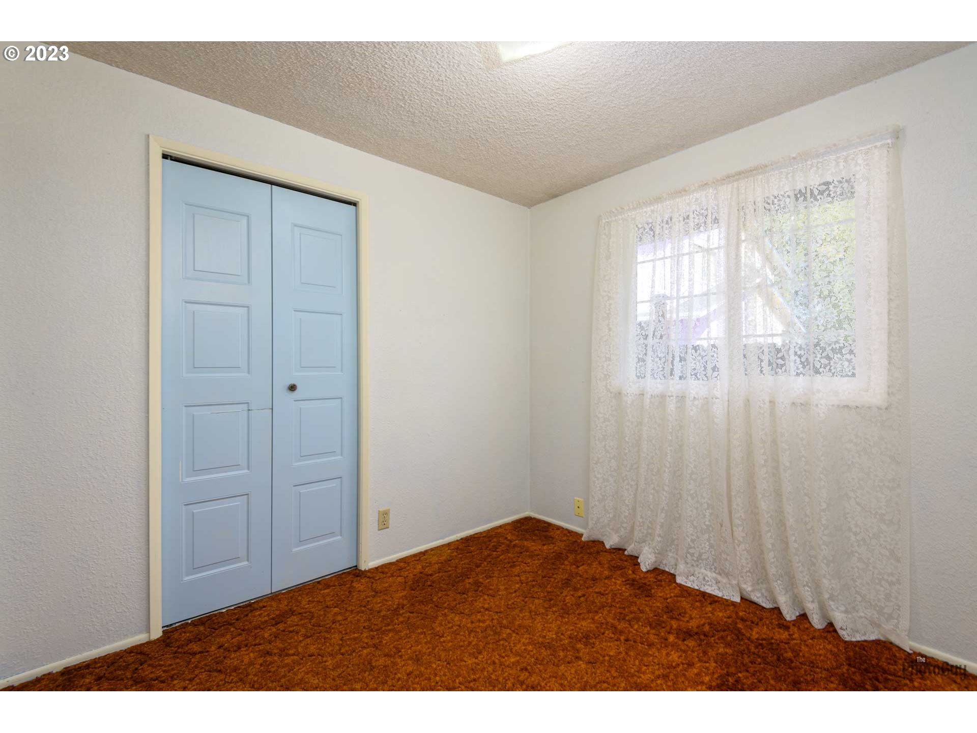 4888 B Street Springfield, OR 97478 - Photo 17 of 32 an empty room with windows and closet